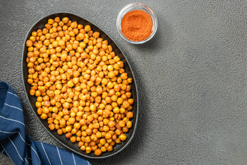 Crispy smoked paprika chickpeas in cast iron skillet on dark background. Top view, copy space.