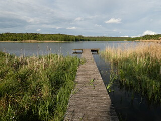Lansdcape with long wooden pier, Schodno lake, Kashubian Lake District, Poland