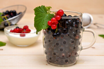 black and red currants in a glass cup close-up