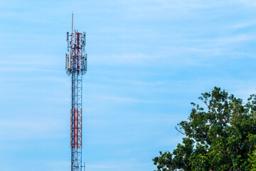 Obraz premium Mobile station receiver antenna tower with fluffy clouds blue sky daylight background.