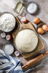 Pizza dough on rustic background. Cooking time. Ingredients for making dough. 