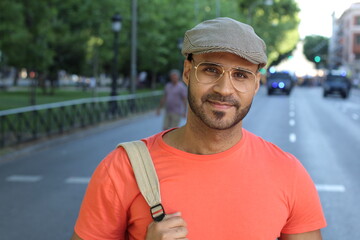 Young man with eyeglasses and beret outdoors 