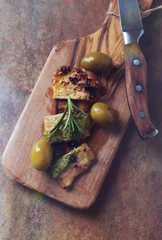 Foto op Plexiglas Fried pork with green olives and fresh rosemary. Rustic stone background. Top view.   © Eugeniusz Dudziński