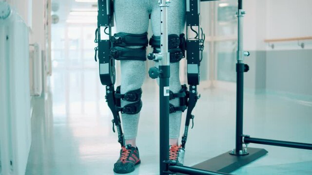 Patient with disability is moving in the exoskeleton