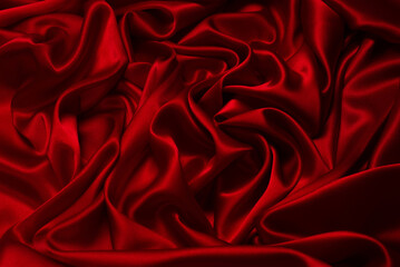 Rich and luxury red silk fabric texture background.