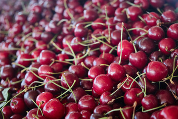 Ripe red sweet cherries on market. Fruit background