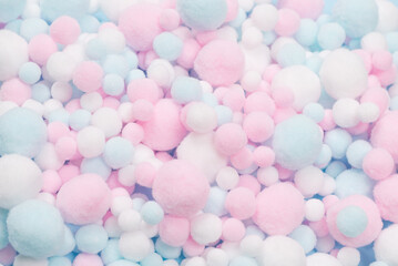 White, pink and blue soft pompons as a background.