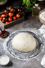 Pizza dough on rustic background. Cooking time. Ingredients for making dough. 