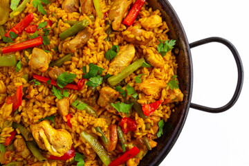 Close-up of Chicken paella on white background, a traditional Valencian (Spanish) dish made of rice...