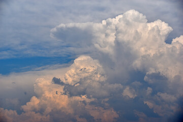 Blue and white cumulus clouds before a thunderstorm