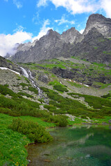 Fototapeta na wymiar Landscape of the High Tatra mountains. Lake Velicke pleso, waterfall Velicky vodopad and mountains. Slovakia.