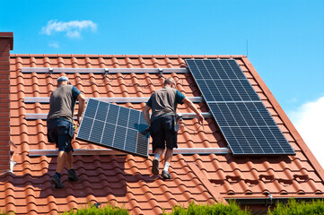 Installing solar panels on house roof - obrazy, fototapety, plakaty