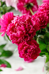 Pink peony flowers bouquet on rustic background with copy space. Women's day or wedding concept. Greeting card