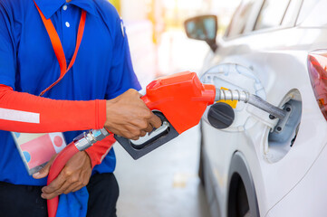 Fototapeta premium Hand Man Refill and filling Oil Gas Fuel at station. Gas station - refueling.To fill the machine with fuel. Car fill with gasoline at a gas station. Gas station pump. 