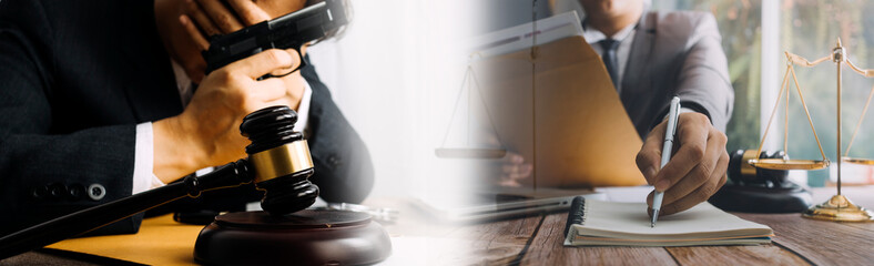 Justice and law concept.Male judge in a courtroom with the gavel, working with, computer and docking keyboard, eyeglasses, on table in morning light