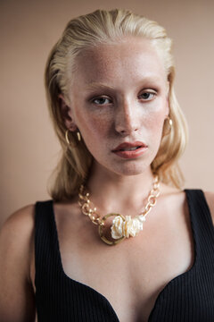 Young model wearing earrings and necklace