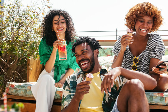 Diverse friends resting on terrace together