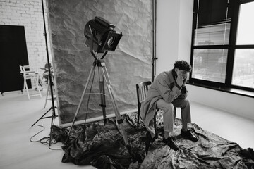 studio portrait of a young curly brown-haired man