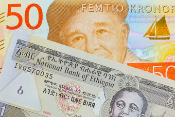 A macro image of a gray and orange fifty kronor note from Sweden paired up with a grey Ethiopian one birr bill.  Shot close up in macro.