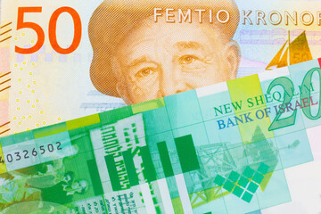 A macro image of a gray and orange fifty kronor note from Sweden paired up with a green and white twenty shekel bill from Israel.  Shot close up in macro.