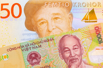 A macro image of a gray and orange fifty kronor note from Sweden paired up with a colorful, plastic ten thousand dong note from Vietnam.  Shot close up in macro.