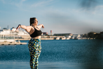 Curvy athlete stretching in fitness training.