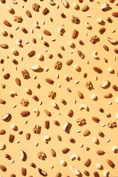 Background of various tasty nuts on beige table