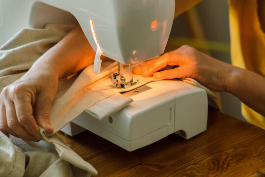 Elderly woman's hands while sewing