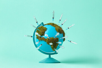 Earth globe with moss and syringes