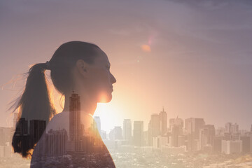 Strong confident woman in the city looking to the sunset. Motivation, success concept. 