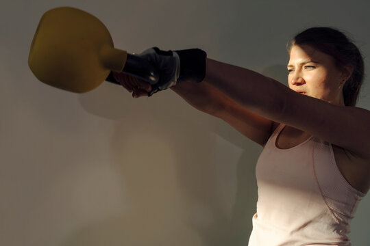 Young woman doing Sport at Home with Weights