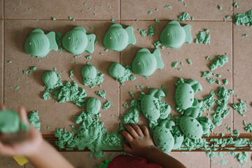 Asian boy playing kinetic sand