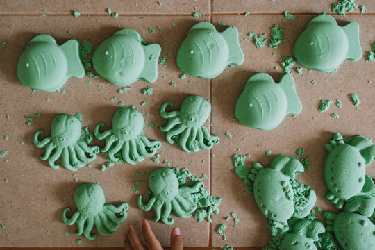 Asian boy playing kinetic sand