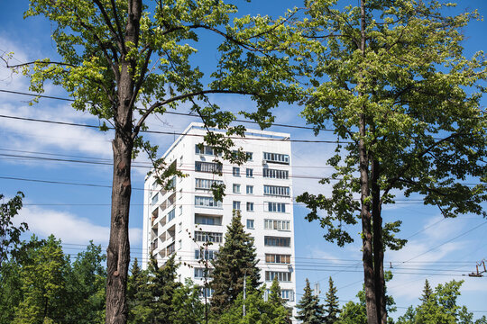 Building Facade Surrounded By Greenery And Wires