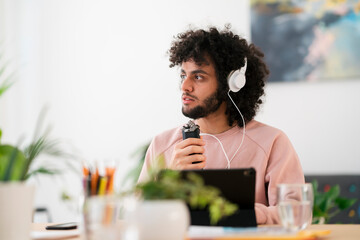 Arab man using audio recorder in studio