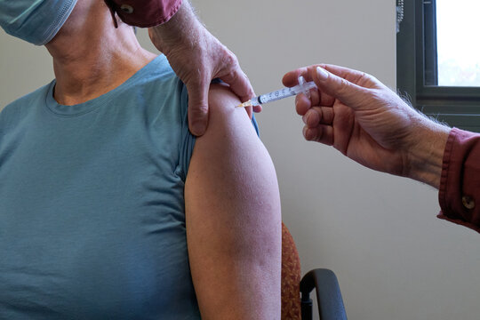 Middle aged women receiving the Covid-19 vaccination