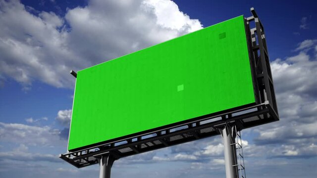Large Green Screen Billboard Advertisement Over Cloudy Sky. Huge green screen advertisement outdoor with a cloudy sky in the background. Pre keyed