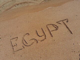 The inscription Egypt on golden sand on the beach