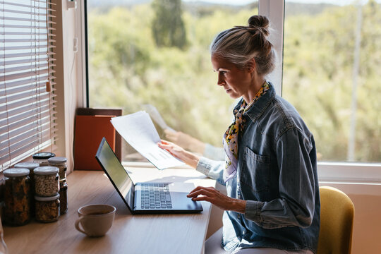Mature freelancer working near window