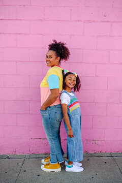 Mother and daughter back-to-back
