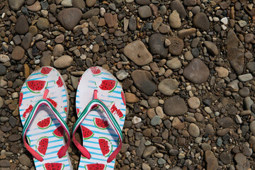 slippers flip flops on a stone beach