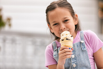 Smiling Girl Enjoys Cookie Ice Cream Cone