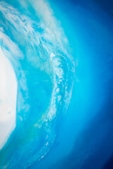 Part of original resin art epoxy resin painting. High quality details. Marble texture. Fluid art for modern banners, ethereal graphic design. Abstract ethereal bronze, blue and white swirl.