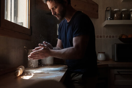 Man cooking a homemade dough pizza 