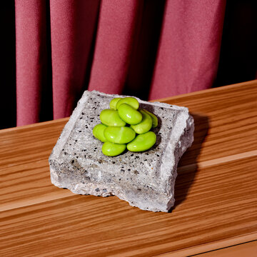 cooked edamame beans on a concrete tile