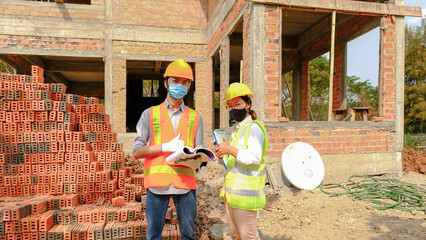 Engineer contractor team meeting work safety plan industry project and check design at the construction building site