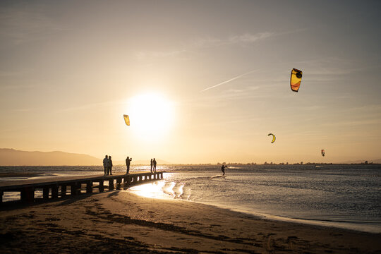 Anonymous man kitesurfing during sunset on the sea
