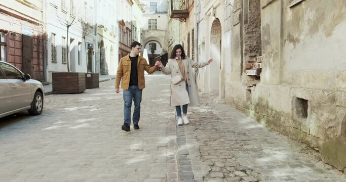 Sweet couple have vacation in old european town. Happy young lovers enjoy time spending together. Walking together in travel