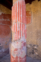 Casa della Gemma in Ercolano with columns. Ruins of ancient roman town Ercolano - Herculaneum, destroyed by the eruption of the Mount Vesuvius, Vesuvio volcano. Historical park of Ercolano, Italy