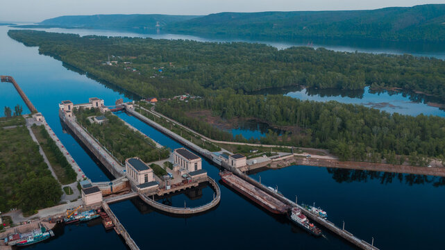 Top-view of a barge ship passing by the gateway